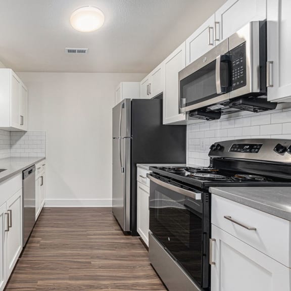 Thumbnail 12 of 22 a modern kitchen with stainless steel appliances and white cabinets  at Signature Pointe Apartment Homes, Athens, AL