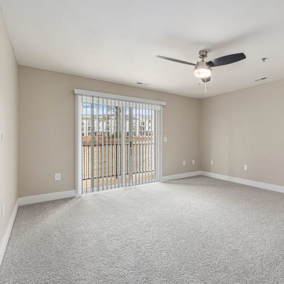 Thumbnail 5 of 22 living room with a ceiling fan and a slider to a balcony  at Signature Pointe Apartment Homes, Athens, 35611