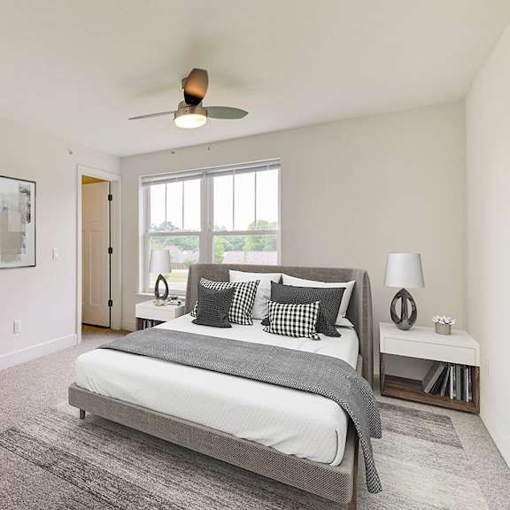 Thumbnail 13 of 20 A bedroom with a large bed and a ceiling fan at Signature Pointe Apartment Homes, Athens