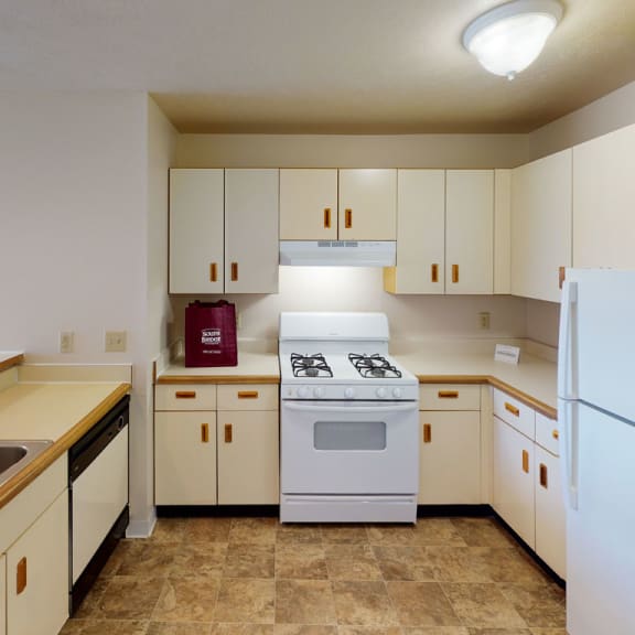 Thumbnail 6 of 8 a kitchen with a breakfast bar at South Bridge Apartments, Indiana, 46816