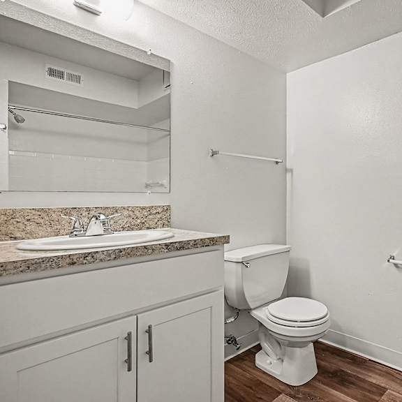 Thumbnail 17 of 24 A white toilet sits in a bathroom next to a sink.
