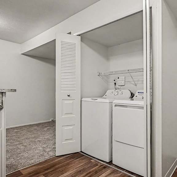 Thumbnail 15 of 24 A white laundry room with a washer and dryer.