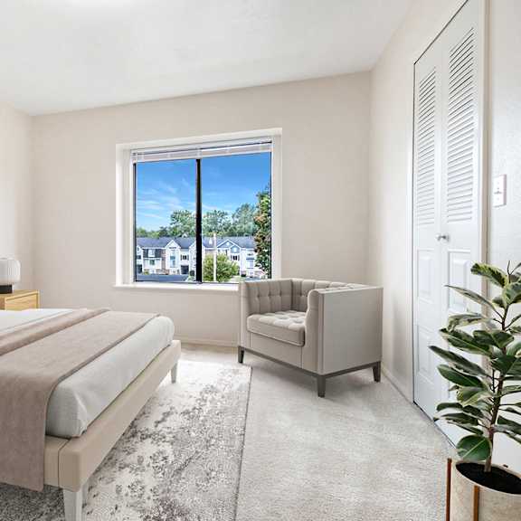 Thumbnail 7 of 7 A bedroom with a large bed and a window overlooking a cityscape at South Bridge Apartments, Indiana