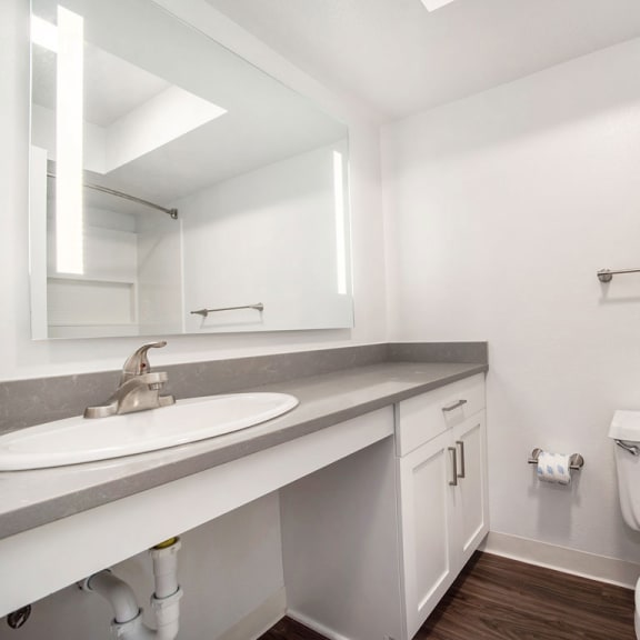Thumbnail 9 of 10 a bathroom with a sink toilet and a mirror at Stoney Pointe Apartment Homes, Kansas, 67226