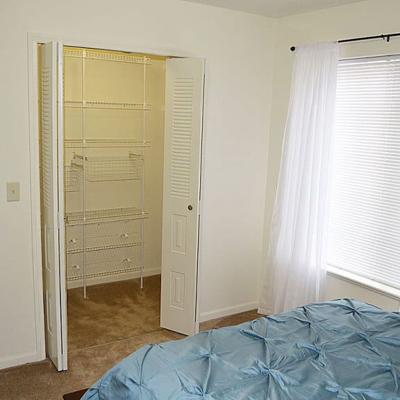 Thumbnail 10 of 10 a bedroom with an empty closet and a bed at Stoney Pointe Apartment Homes, Wichita, KS, 67226