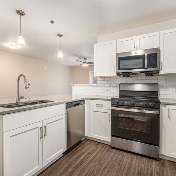 Thumbnail 7 of 10 a kitchen with white cabinets and stainless steel appliances at Stoney Pointe Apartment Homes, Wichita, KS