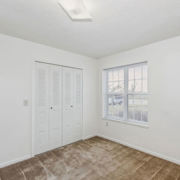 Thumbnail 11 of 13 a bedroom with a window and a closet at Stoney Pointe Apartment Homes, Kansas, 67226