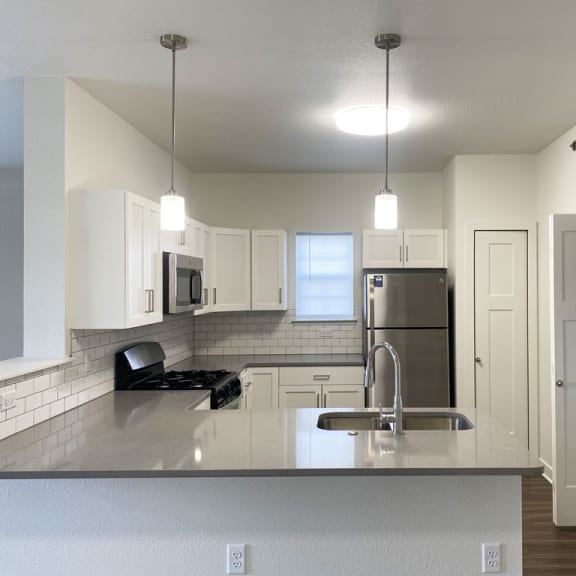 Thumbnail 6 of 10 a kitchen with a window and washer and dryer at Stoney Pointe Apartment Homes, Wichita, KS