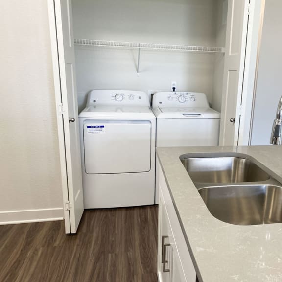 Thumbnail 8 of 10 a kitchen with a sink and a washer and dryerat Stoney Pointe Apartment Homes, Kansas, 67226