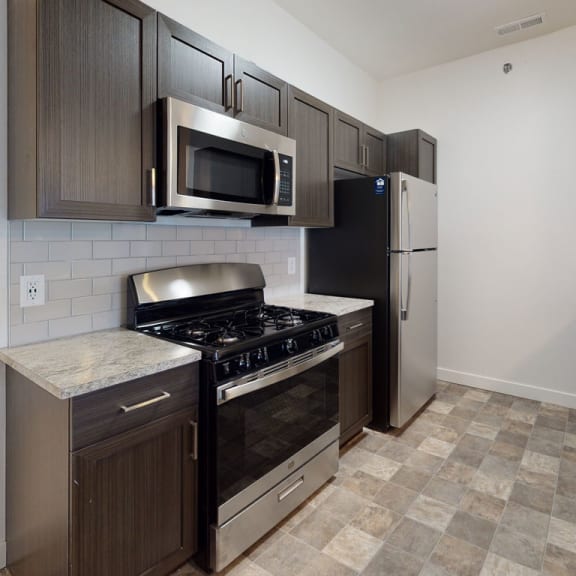 Thumbnail 8 of 14 A kitchen with stainless steel appliances at Strathmore Apartment Homes, West Des Moines, IA, 50266
