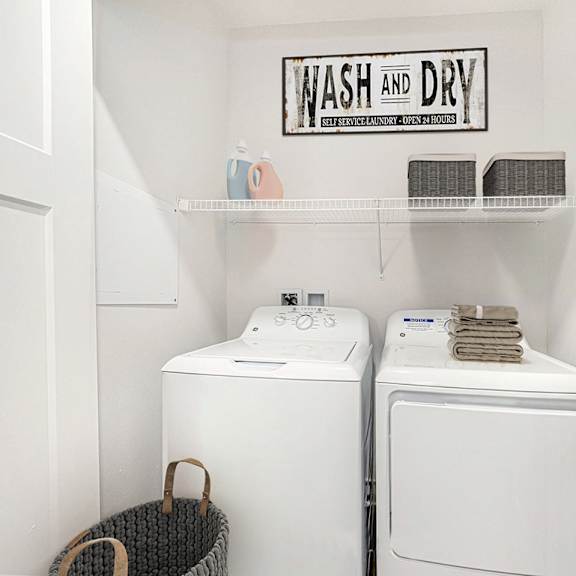 Thumbnail 9 of 13 a washer and dryer in the laundry room of a home at Strathmore Apartment Homes, West Des Moines, Iowa