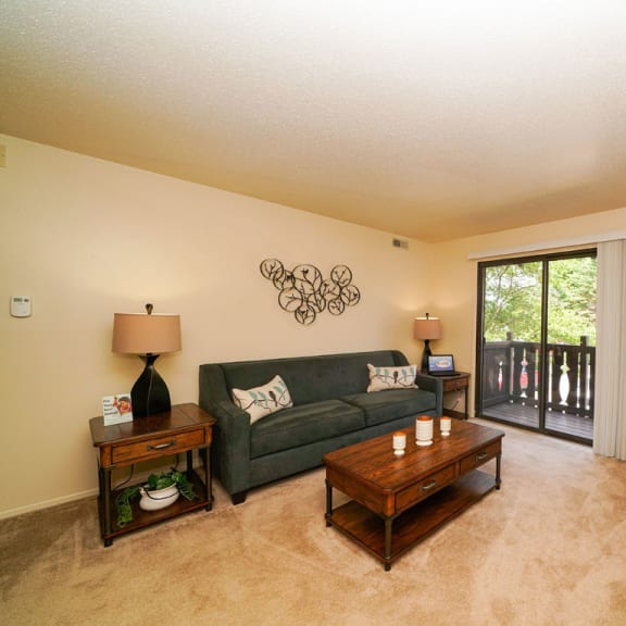 Thumbnail 3 of 9 a living room with a couch and a television at Swiss Valley Apartments, Wyoming, MI