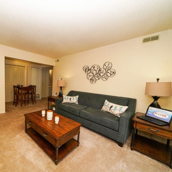 Thumbnail 4 of 9 a living room with a couch and a coffee table at Swiss Valley Apartments, Wyoming
