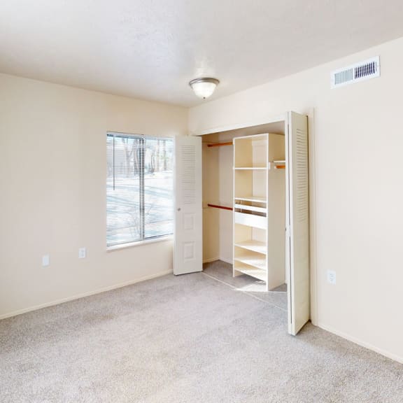 Thumbnail 7 of 7 a bedroom with a closet and a large window  at Swiss Valley Apartments, Wyoming