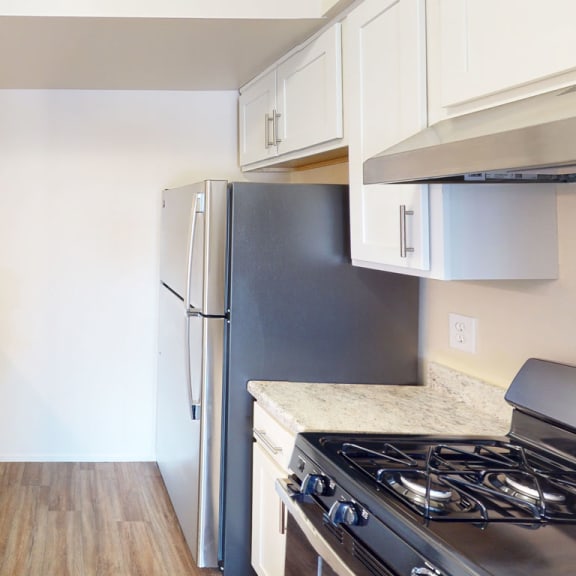 Thumbnail 5 of 7 a kitchen with stainless steel appliances and white cabinets  at Swiss Valley Apartments, Wyoming, MI, 49509