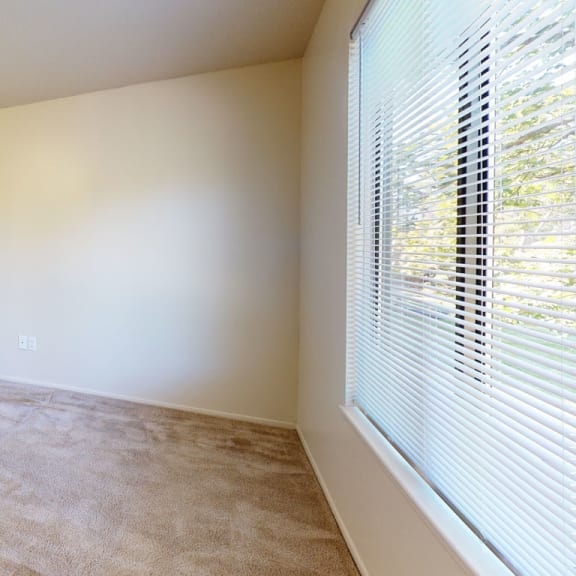 Thumbnail 10 of 10 a bedroom with a large window and a door to a hallway