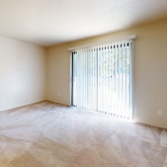 Thumbnail 4 of 10 an empty room with white walls and a window at Swiss Valley Apartments, Wyoming, 49509