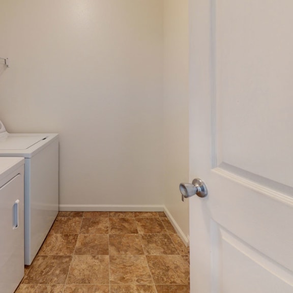 Thumbnail 13 of 13 Laundry room with washer and dryer at Tall Oaks Apartment Homes, Kalamazoo, Michigan