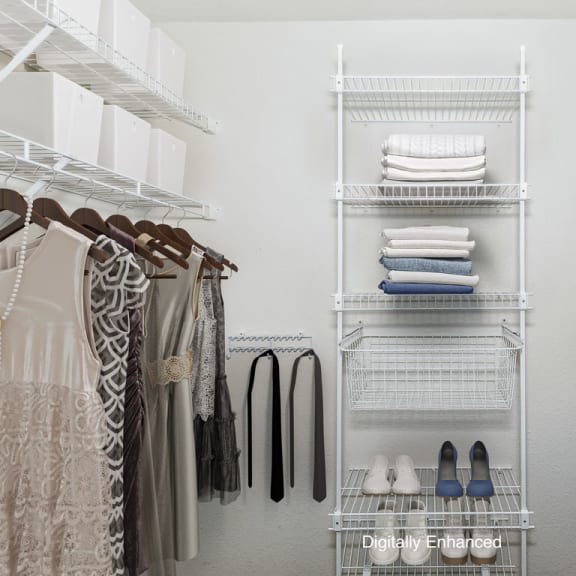 Thumbnail 9 of 13 a walk in closet with wardrobe organizers at Tall Oaks Apartment Homes, Michigan