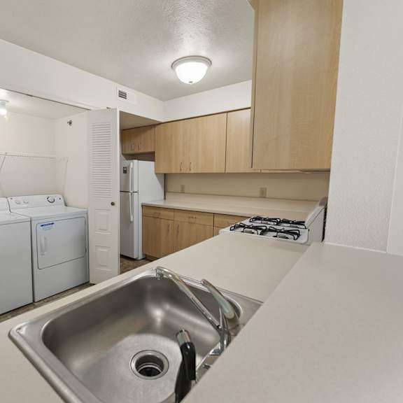 Thumbnail 6 of 9 A kitchen with a washer and dryer at Tall Oaks Apartment Homes, Kalamazoo, MI, 49009
