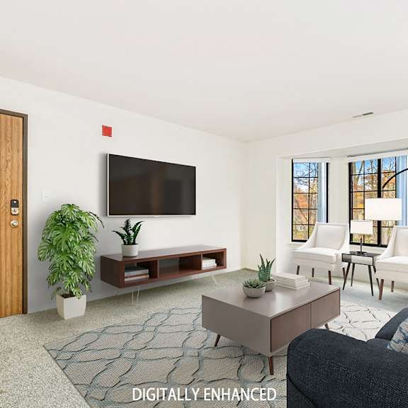 Thumbnail 4 of 20 A living room with a bay window, a couch, and a rug  at Tanglewood Apartments, Oak Creek, WI