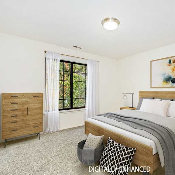 Thumbnail 18 of 20 A bedroom with a large bed, a nightstand, and a window  at Tanglewood Apartments, Oak Creek, WI