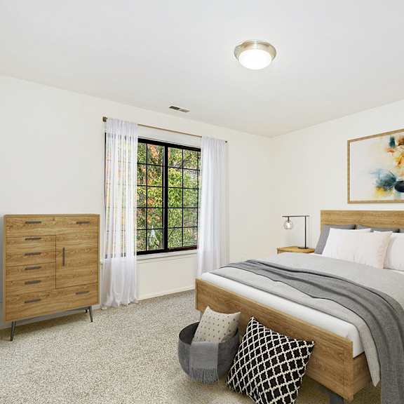 Thumbnail 17 of 19 A bedroom with a large bed, a nightstand, and a window  at Tanglewood Apartments, Oak Creek, WI