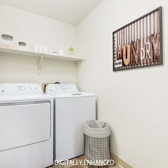 Thumbnail 14 of 20 A laundry room with a washer and dryer and a shelf  at Tanglewood Apartments, Oak Creek, WI