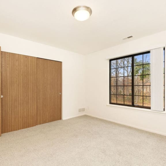 Thumbnail 20 of 20 bedroom with large window and closet at Tanglewood Apartments, Oak Creek, WI