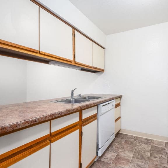 Thumbnail 13 of 20 a kitchen with a sink, refrigerator and dishwasher at Tanglewood Apartments, Oak Creek, WI, 53154