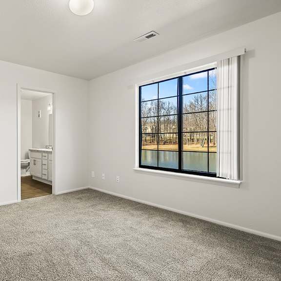 Thumbnail 13 of 19 A bedroom with an ensuite bathroom and a closet at Tanglewood Apartments, Oak Creek, WI