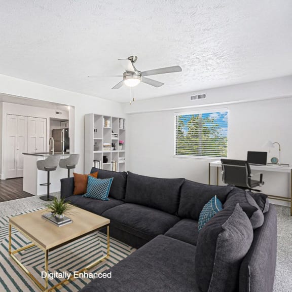 Thumbnail 5 of 13 enlarged living room with a ceiling fan at The Crossings Apartments, Michigan, 49508