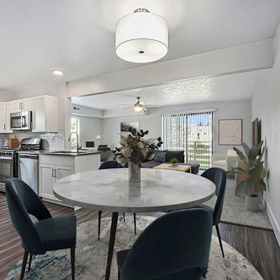 Thumbnail 3 of 12 A modern kitchen with a dining table set for four at Byron Lakes Apartments, Michigan, 49315