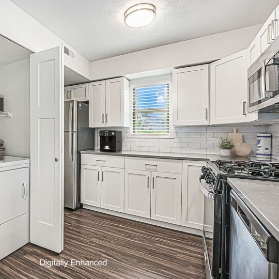 Thumbnail 8 of 13 kitchen with a washer and dryer and a window at The Crossings Apartments, Michigan, 49508