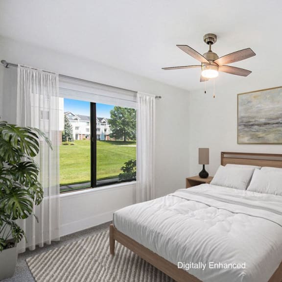 Thumbnail 11 of 15 bedroom with a large window at The Crossings Apartments, Michigan, 49508