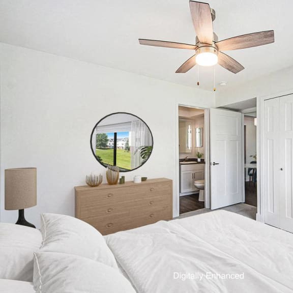 Thumbnail 13 of 15 a bedroom with a ceiling fan at The Crossings Apartments, Michigan, 49508