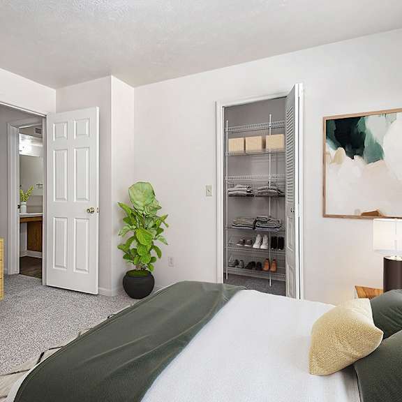 Thumbnail 9 of 9 A bedroom with a bed, dresser, and a walk in closet at The Highlands Apartments, Indiana