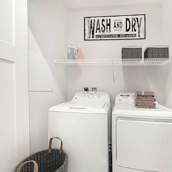 Thumbnail 7 of 11 A laundry room with a full size washer and dryer at Trade Winds Apartment Homes, Elkhorn, NE