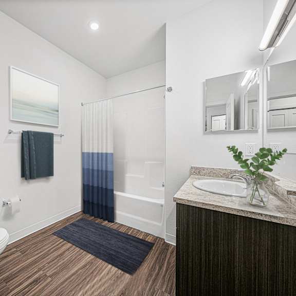 Thumbnail 7 of 11 main bathroom with a toilet sink and a shower at Trade Winds Apartment Homes, Elkhorn, Nebraska