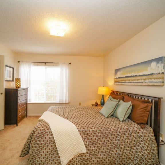 Thumbnail 6 of 6 a bedroom with a bed and a window at Trillium Pointe Apartment Homes, Jackson, 49201