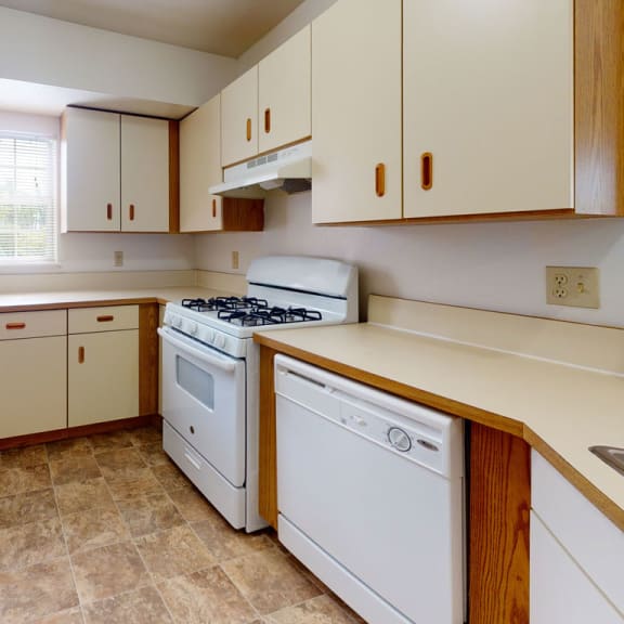Thumbnail 3 of 7 a kitchen with white appliances and white cabinets at Trillium Pointe Apartment Homes, Jackson