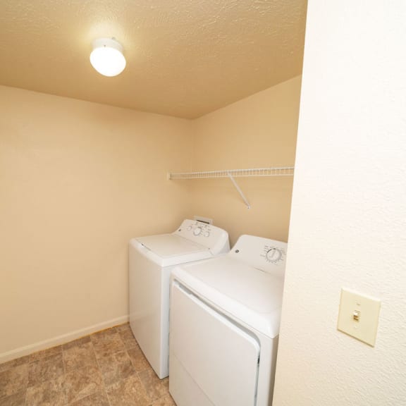 Thumbnail 6 of 12 a bedroom with two beds and a closet at Trillium Pointe Apartment Homes, Jackson, Michigan