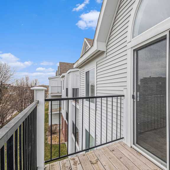 Thumbnail 4 of 19 A balcony with enclosed, private storage and sliding glass doors at Trillium Pointe Apartment Homes, Michigan, 49201