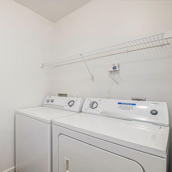Thumbnail 10 of 19 A laundry room with a full size washer and dryer at Trillium Pointe Apartment Homes, Michigan, 49201