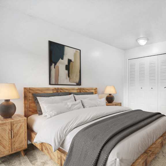 Thumbnail 5 of 5 A bedroom with a large bed and closet at Walnut Trail Apartments, Portage, MI, 49002