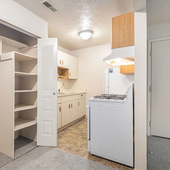Thumbnail 6 of 11 Kitchen and a large closet with shelving at Waverly Park Apartments in Lansing, MI 48911