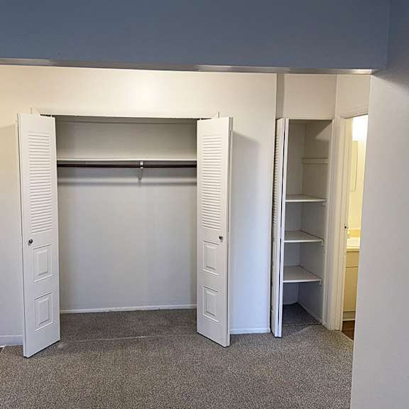 Thumbnail 5 of 11 A dining room with a closet and a linen closet with shelves at Waverly Park Apartments, Lansing