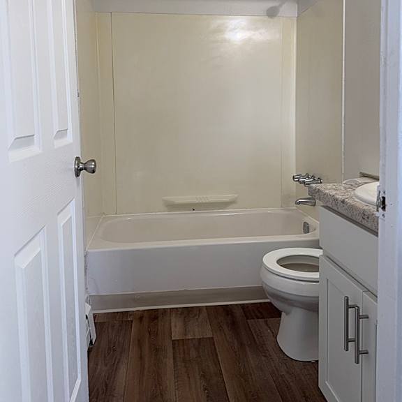 Thumbnail 9 of 12 A bathroom with a toilet, sink, and bathtub at Waverly Park Apartments, Lansing