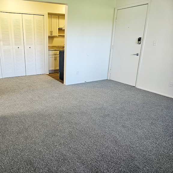 Thumbnail 4 of 15 A dining room with a carpeted floor at Waverly Park Apartments, Lansing