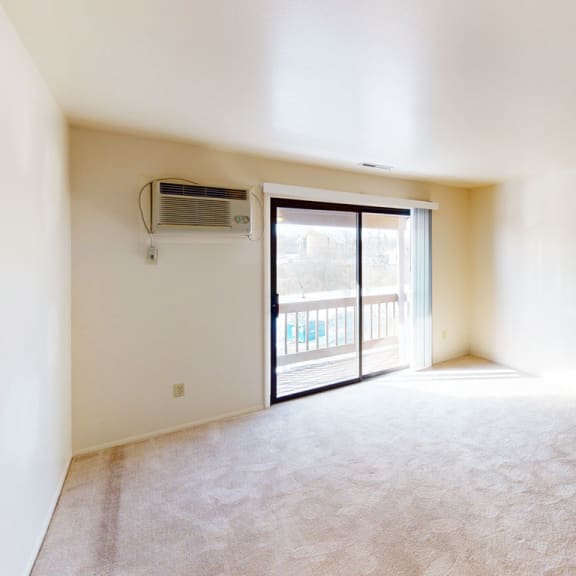 Thumbnail 5 of 11 spacious living room with plush carpeting at West Wind Apartments, Fort Wayne, Indiana
